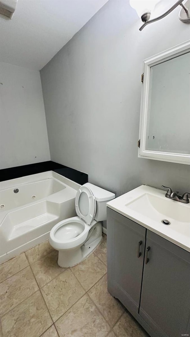 bathroom with toilet, a bathtub, vanity, and tile patterned flooring