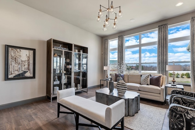 living room with a chandelier and dark hardwood / wood-style flooring