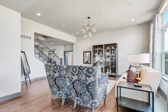 living room with a chandelier and hardwood / wood-style floors