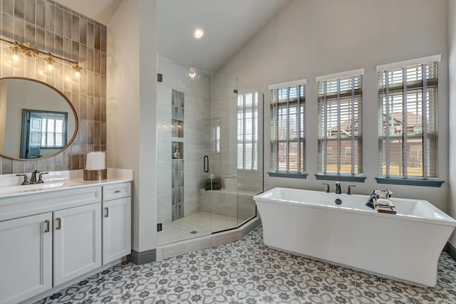 bathroom featuring vanity, lofted ceiling, plus walk in shower, tile patterned flooring, and tile walls