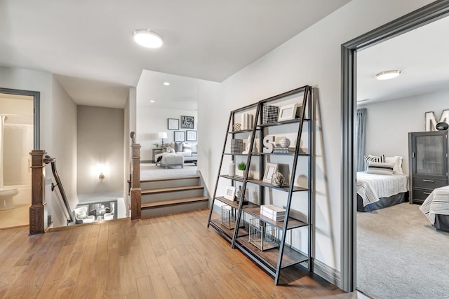 hallway with light hardwood / wood-style floors