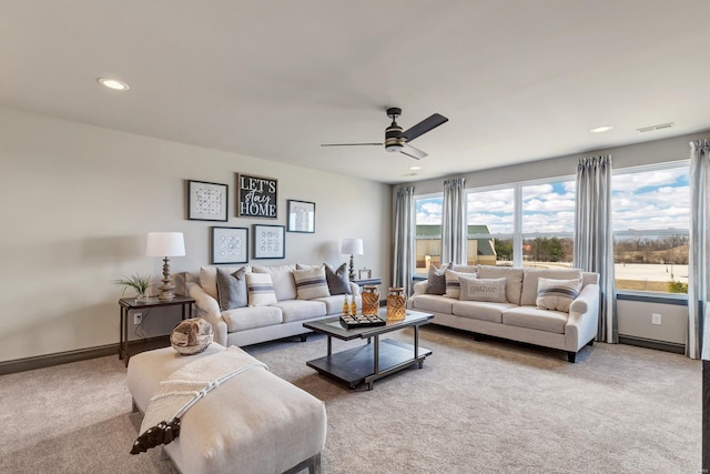 living room with ceiling fan and carpet