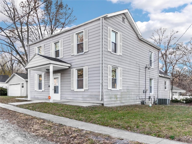 view of front of home with a front lawn and central AC unit