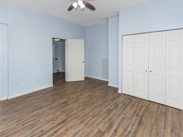 unfurnished bedroom with a closet, dark hardwood / wood-style floors, and ceiling fan