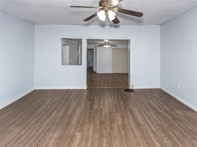 unfurnished room featuring dark hardwood / wood-style floors and ceiling fan