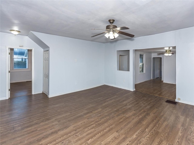 unfurnished living room with dark hardwood / wood-style floors and ceiling fan