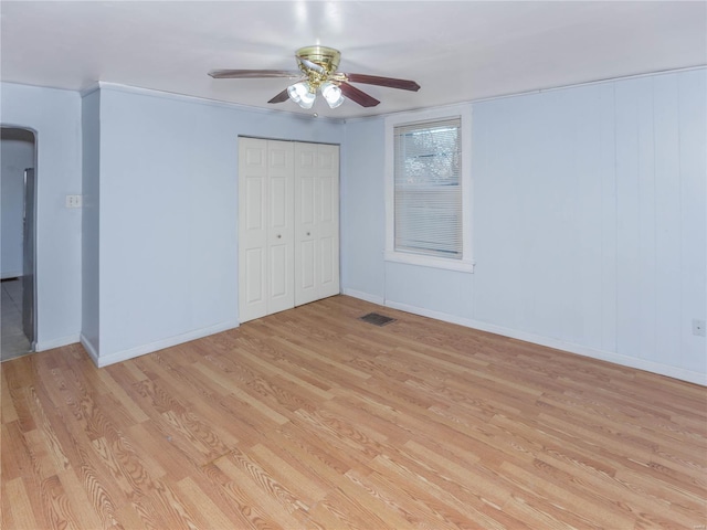 unfurnished bedroom with a closet, light hardwood / wood-style floors, and ceiling fan