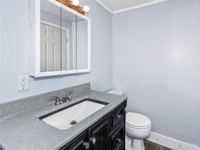 bathroom with wood-type flooring, vanity, and toilet