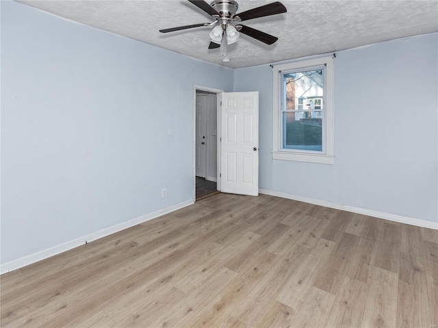 unfurnished room featuring ceiling fan, a textured ceiling, and light hardwood / wood-style flooring