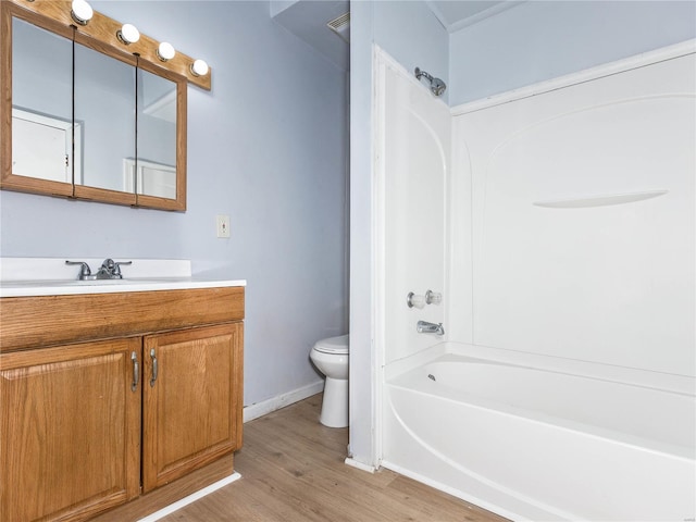 full bathroom with wood-type flooring, vanity, toilet, and tub / shower combination