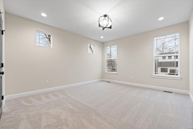 carpeted empty room featuring recessed lighting and baseboards