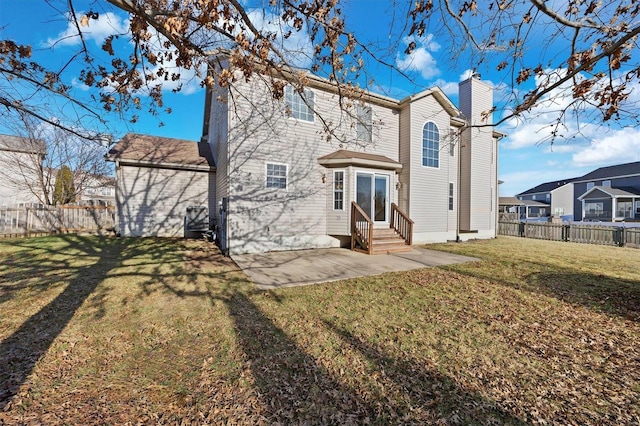 back of house with a patio and a yard