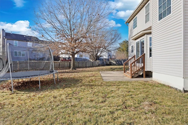 view of yard featuring a patio area and a trampoline