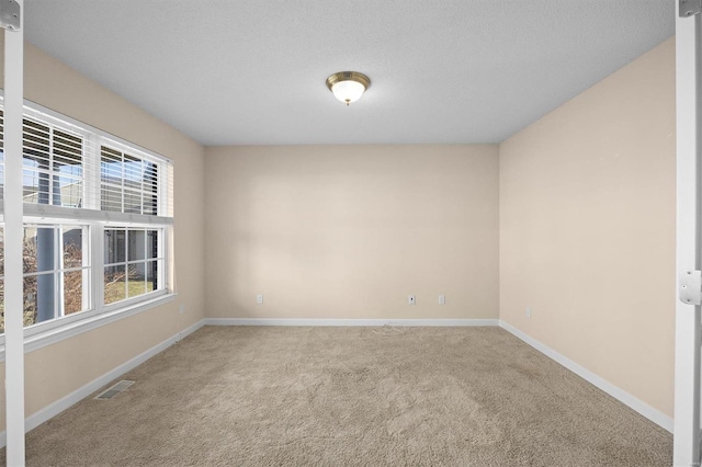 unfurnished room featuring carpet flooring