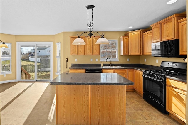 kitchen featuring sink, decorative light fixtures, black appliances, and a kitchen island