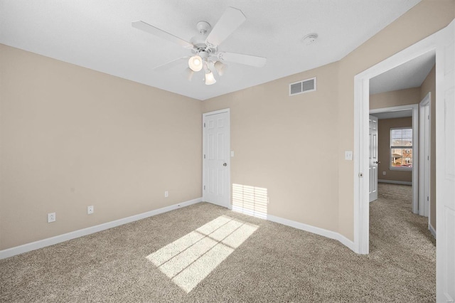 carpeted empty room with ceiling fan