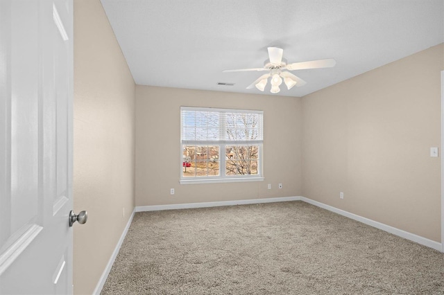 empty room featuring carpet and ceiling fan