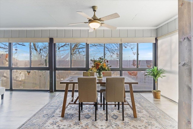 sunroom / solarium featuring ceiling fan and a healthy amount of sunlight