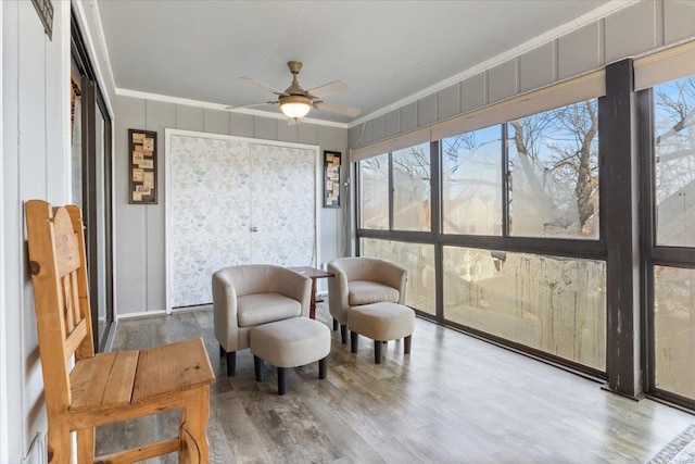 sunroom featuring ceiling fan