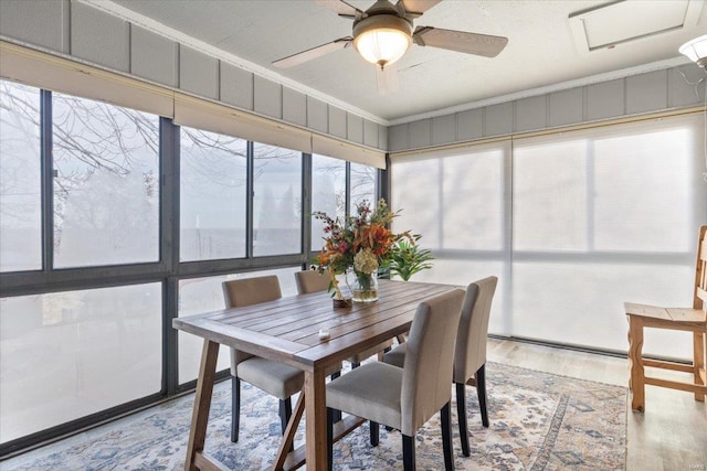 sunroom / solarium featuring ceiling fan