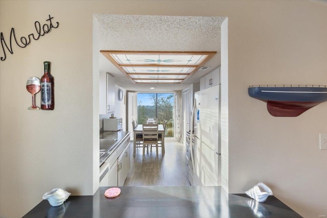 hallway with hardwood / wood-style flooring