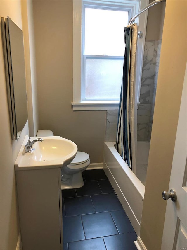 full bathroom featuring tile patterned flooring, vanity, toilet, and shower / bath combo with shower curtain