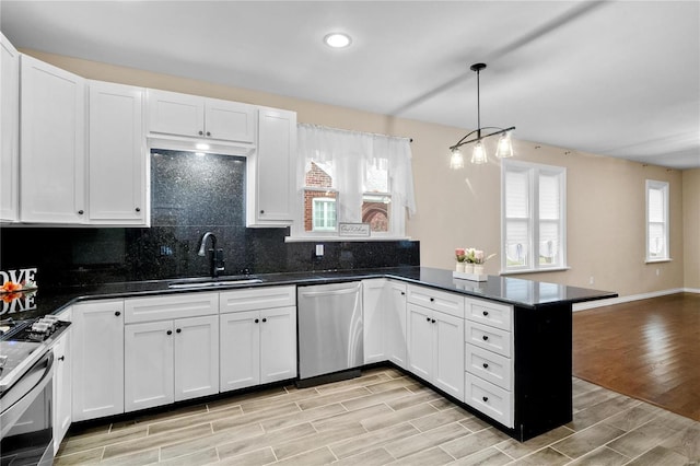 kitchen with sink, light wood-type flooring, stainless steel appliances, and a wealth of natural light