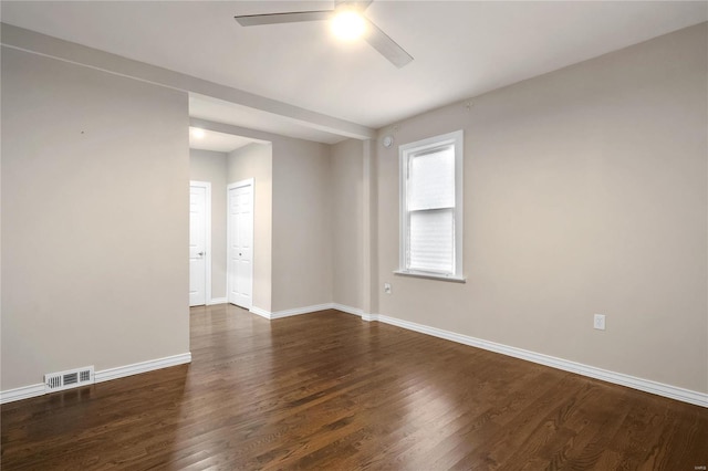 spare room featuring ceiling fan and dark wood-type flooring