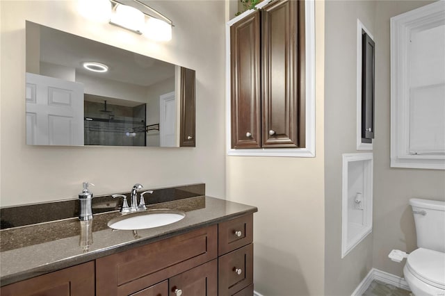 bathroom with vanity, toilet, and walk in shower