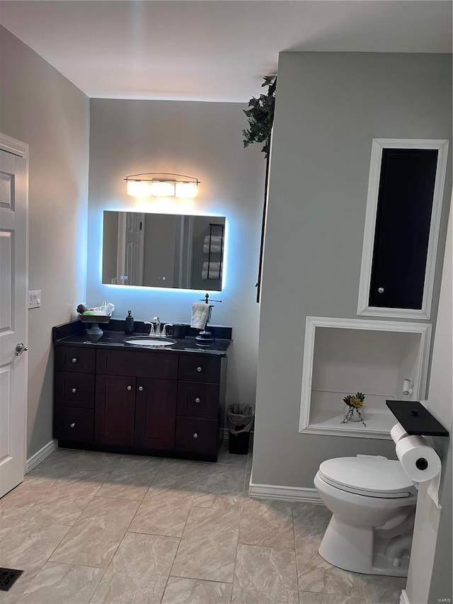 bathroom featuring vanity and toilet