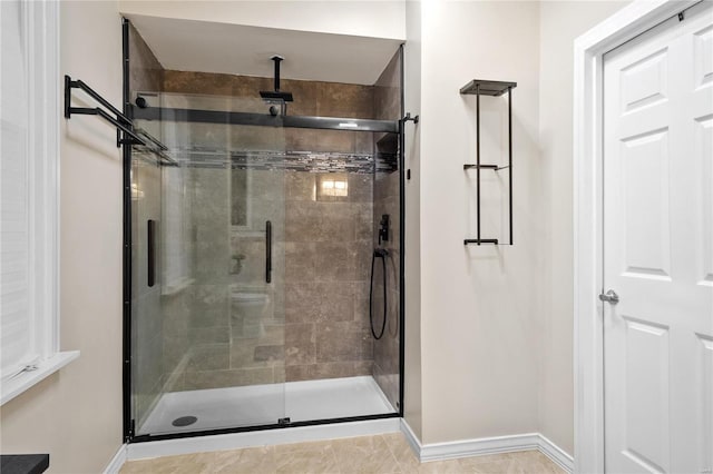 bathroom with tile patterned flooring and an enclosed shower