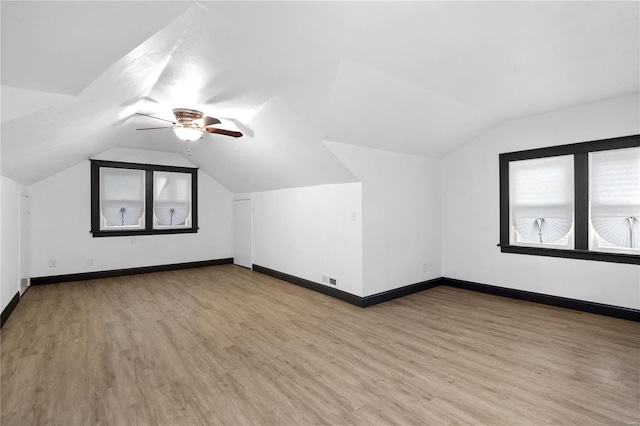 additional living space with hardwood / wood-style floors, ceiling fan, and lofted ceiling