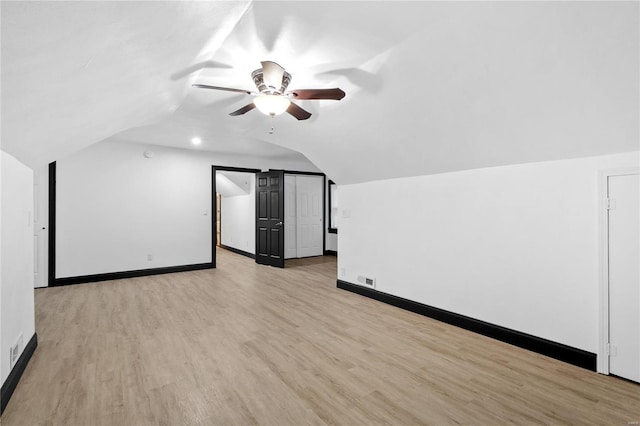 bonus room with ceiling fan, light hardwood / wood-style floors, and vaulted ceiling