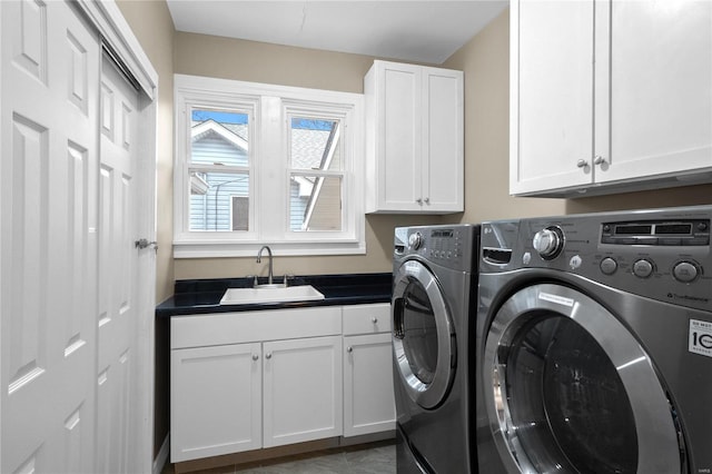 washroom with washing machine and clothes dryer, sink, and cabinets