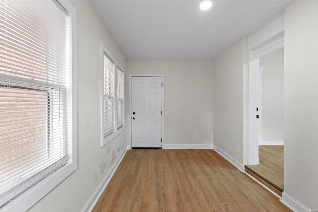 corridor with light hardwood / wood-style flooring