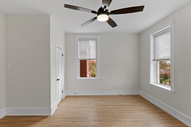 spare room with ceiling fan and light wood-type flooring