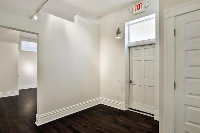 foyer featuring dark hardwood / wood-style flooring and rail lighting