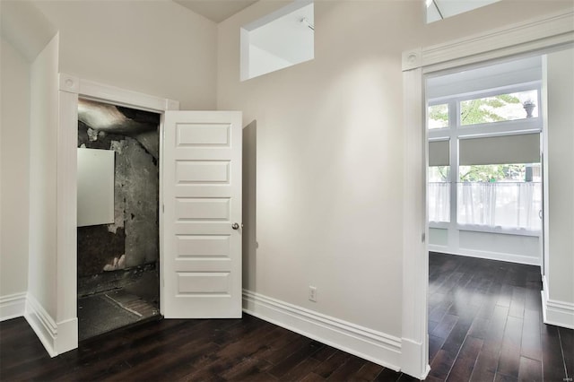 unfurnished bedroom with dark hardwood / wood-style flooring