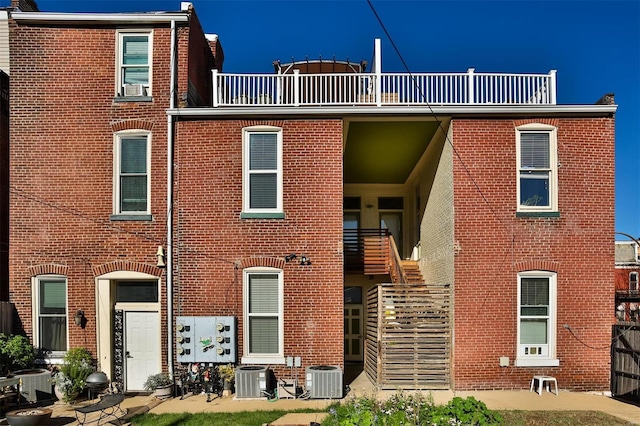 view of front of house with a balcony and central AC unit