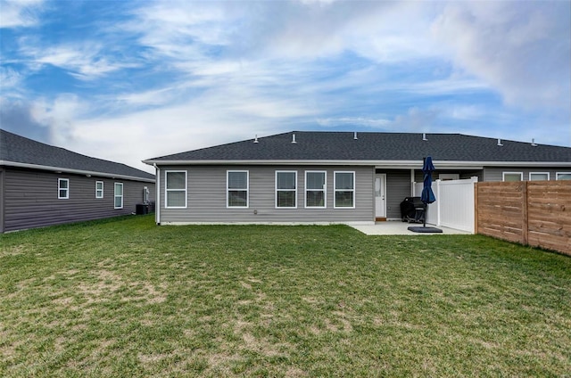 back of property featuring central air condition unit, a patio area, and a yard