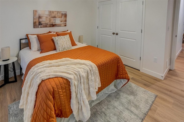 bedroom featuring a closet and light wood-type flooring