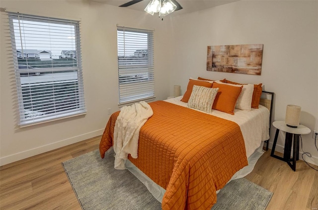 bedroom with ceiling fan and light wood-type flooring