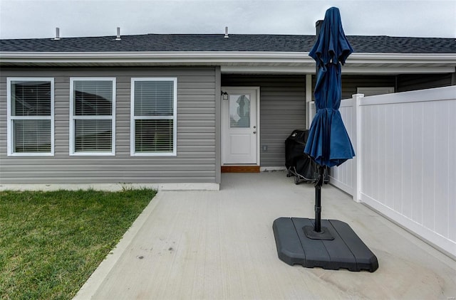 view of exterior entry with a patio area