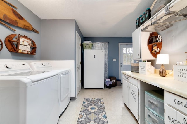 laundry area featuring cabinets and independent washer and dryer