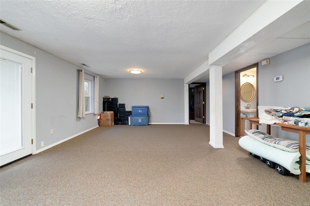 basement with a textured ceiling and carpet floors