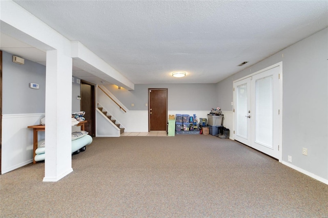 basement with carpet flooring and a textured ceiling