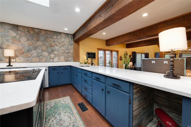 kitchen featuring black electric stovetop, beam ceiling, dark hardwood / wood-style flooring, and kitchen peninsula