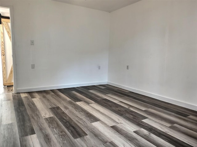 unfurnished room featuring dark wood-type flooring