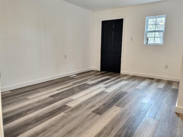 unfurnished room featuring hardwood / wood-style floors