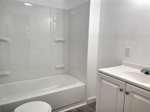 full bathroom featuring shower / bathing tub combination, vanity, hardwood / wood-style flooring, and toilet